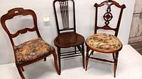 Group photo of three vintage wood opera chairs: two with floral fabric upholstery and one spindle back chair with wooden seat.