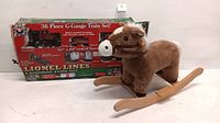 Front view of plush rocking horse in front of Lionel Christmas train set box, showing size and condition.