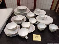 Photo showing Mikasa Sirocco and Regency China teacups, saucers, and a variety of plates on table
