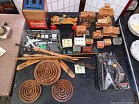 Full lot overview showing Star Trek Spock toy in package, wooden keepsake boxes, pull toy dogs, mail box bank, boomerang, arrows, diecast Air France plane set, and wooden mazes.