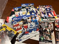Close-up view of several hockey cards featuring players from the Toronto Maple Leafs and other teams, including Mike Modano and Daniel Marois.