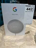Front view of the sealed Google Nest Mini box showing the product image and branding.