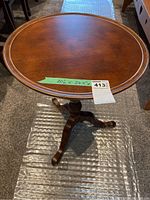 Round wooden side table with notes measuring 20"D x 26.5"H with seller tag