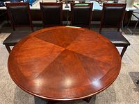 Top-down view of the round wooden dining table showing the wood grain finish.