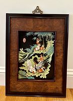 Full view of framed porcelain panel showing hens and roosters with bamboo background on black porcelain.