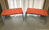 Front view of both benches with orange dragonfly print cushions installed