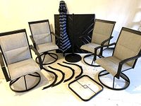 Four swivel chairs, table, umbrella and stand, plus disassembled table legs.