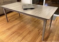 Three-quarter view of table showing tapered legs and tray on top