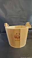 Front side of wooden bucket showing WWF logo