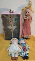 Three dolls including Armand Marseille porcelain head doll and two Holly Hobbie dolls, alongside vinyl ballet box with ballerina print