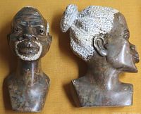 Pair of carved stone busts of a man and woman shown side by side from front and side views on a yellow background.