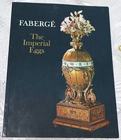 Front cover of the 'Fabergé: The Imperial Eggs' book showcasing an ornate Fabergé egg with floral bouquet