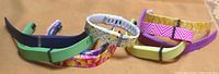 Multiple Fitbit Flex replacement bands laid face up showing varied floral and solid color designs