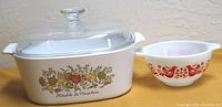 Photo showing the Corning casserole dish with lid and the Pyrex 213 mixing bowl side by side on a surface.