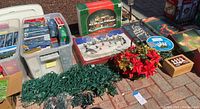 First image showing bins of boxed lights, loose green strands, poinsettias and tabletop decor