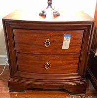 Front view of nightstand showing two drawers and ring pull handles