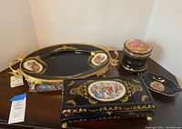 Photo of entire Moroni Powder Box Set with tray, covered powder box, decorative box, and small dish on wooden surface.