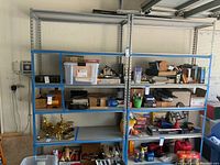 Front view of two metal shelving units filled with various objects.