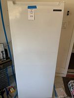 Closed front view of white Thomson upright freezer showing the clean exterior and brand label.
