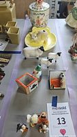 Photo showing Beswick sheep figurines, Big Top Lollipops container with clown lid, cat cotton dispenser, small clown figurines, and decorative ashtrays.