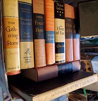 Photo of 8 Churchill books, some with visible dust jackets, arranged on a shelf