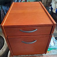 Front view of the wood filing cabinet showing two drawers with metal handles and the side lock area.