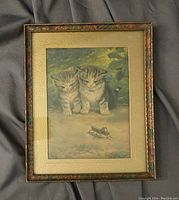 Front view of the framed print showing two kittens watching a grasshopper in a natural setting