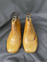 Top view of two wooden shoe forms for children, showing toe and front shape.