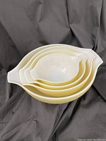 Four nested Pyrex Shenandoah bowls stacked inside each other, showing the set and their shape.