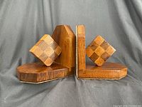 Front view of wood bookends showing diamond inlaid design and shape