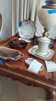 Full view of the table showing Royal Porzellan Bavaria plate holder, glass ashtray with pipe, and additional plates and ashtrays.