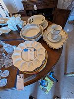 Overview of assorted Lenox dinnerware arranged on table showing plates, bowls, cups, saucers, and serving pieces.