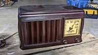 Front view of classic automatic radio showing vintage design with analog dial, grille, and control knobs.