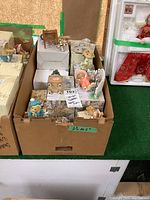 Box showing approximately 10 Cherished Teddies figurines with some original boxes visible inside the lot box.