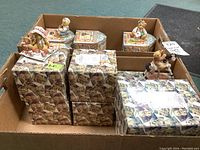 Box holding 13 Cherished Teddies figurines, each with its original box, showing packaging and organized collection