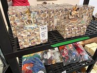 Shelf of approximately 11 Cherished Teddies figurine boxes showing multiple original boxes stacked, brand label visible.