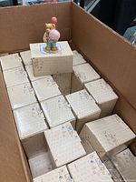 Box containing approximately 72 figurines in original boxes with one displayed figurine on top.