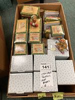 Wide view of the open box showing multiple original boxes of Cherished Teddies ornaments and a few visible figurines.