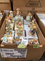 Box containing about 15 Cherished Teddies bear collectible figurines with original boxes, sized approximately 3 to 4 inches.