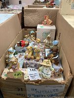 Box with approximately 14 Cherished Teddies bear collectibles in assorted clothes and poses, many with original boxes underneath