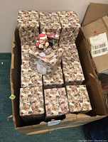 Box full of approximately 40 unopened Cherished Teddies Sanford figurine boxes with one figurine displayed on top.