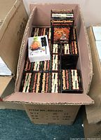 Wide view of box filled with approximately 36 Cherished Teddies Pumpkin Carving Sets in original packaging boxes.