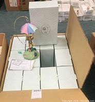 Box containing approximately 12 Cherished Teddies Rusty figurine boxes stacked inside