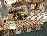 Full view of four Teddies In Motion figurines set up with multiple boxed figurines stacked behind.