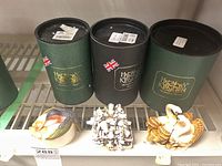 Three Harmony Kingdom figures with original tubes; hummingbird, mice cluster, and swans.