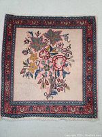 Front side of the Persian Ardebil rug showing unique floral design and color palette.
