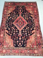 Full view of the Persian Nahavand rug showing the medallion design and color pattern.