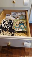 Drawer view showing entire assortment of necklaces, bracelets and earrings