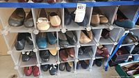 Overall view of multiple pairs of women's shoes in cube storage with various colors and styles.