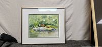 Full view of the watercolor duck painting in its frame, measuring 13.5 x 11.5 inches